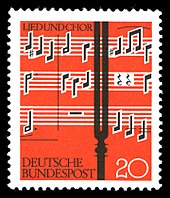 Briefmarke mit Stimmgabel vor dem Notentext des Liedes In dulci jubilo aus Praetorius' Sammelwerk Musae Sioniae (Quelle: Wikimedia)