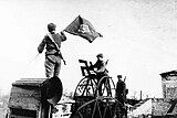 Советский солдат срывает свастику с ворот завода имени Войкова в освобожденной Керчи