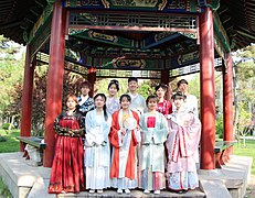 Hanfu enthusiasts holding round-shaped tuanshan