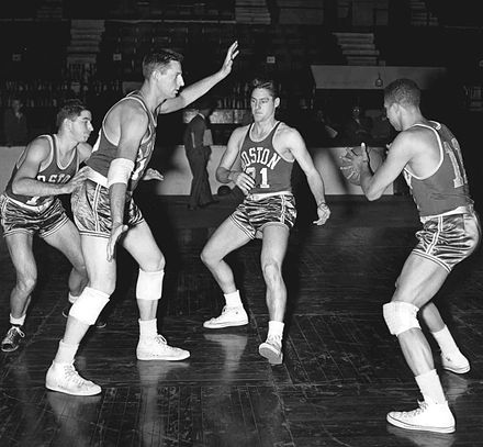 The 1953–54 Boston Celtics basketball team practicing the pick and roll. From left to rightː Bob Donham, Ed Mikan, Bill Sharman and Chuck Cooper.