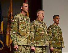 Oregon Army National Guard Brig. Gen. William J. Edwards (left), Land Component Commander; Col. Gregory T. Day (center), outgoing commander; and Lt. Col. (promotable) Stephen L. Schmidt (right), incoming commander, stand at attention during the beginning of a change of command ceremony for the 82nd Brigade (Troop Command), June 3, 2017, at Camp Withycombe in Clackamas, Oregon. 82nd Brigade Troop Command 170603-Z-OT568-006 (35103962015).jpg