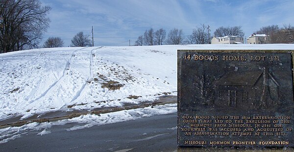 Marker on the Mormon Walking Tour commemorating the spot where Boggs house was located. The marker is in a cleared patch of snow on the sidewalk (to t