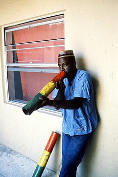 Boulou Bertrand demonstrating Haitian vaksin blowing - North Miami Beach, Florida (June 1990. Cantrell, Brent, Collector) FA5095 - State Archives of Florida, Florida Memory.jpg