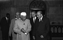 Indian Prime Minister Jawaharlal Nehru wearing Nehru Jacket suit and Topi on a visit to East Germany, 1959. Bundesarchiv Bild 183-61849-0001, Indien, Otto Grotewohl bei Ministerprasident Nehru.jpg