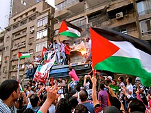 On 15 May 2011, Egyptian protesters waved Palestinian flags in front of the Israeli embassy in Giza as they burned a makeshift Israeli flag. Burning the Israeli flag at embassy in Cairo.jpg