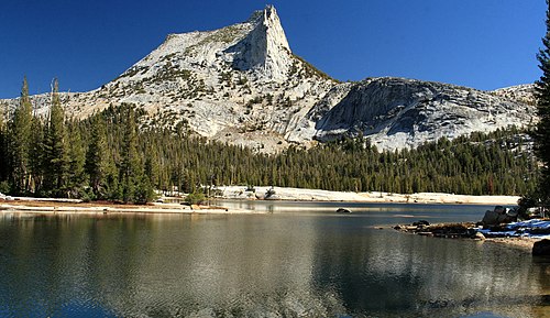 Lower Cathedral Lake, in the foreground, occupies a basin excavated in the granite by the ancient glaciers. Cathedral Peak is behind, Eichorn Pinnacle visible, just left of the summit. Both are nunataks. Cathedral Peak and Lake in Yosemite.jpg