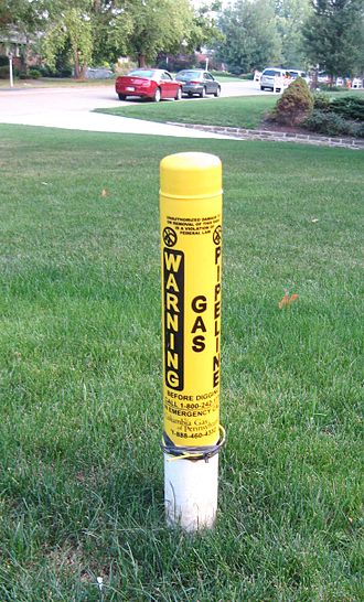 A warning marker indicating an underground gas line Columbia Gas marker jeh.JPG