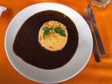 Mole sauce, which has dozens of varieties across the Republic, is seen as a symbol of Mexicanidad and is considered Mexico's national dish. Comida en la Feria del Mole 2014 12.JPG