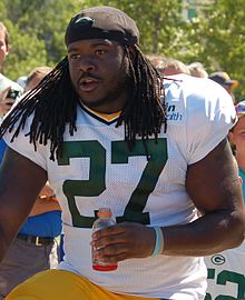 Eddie Lacy in uniform while holding a sports drink bottle
