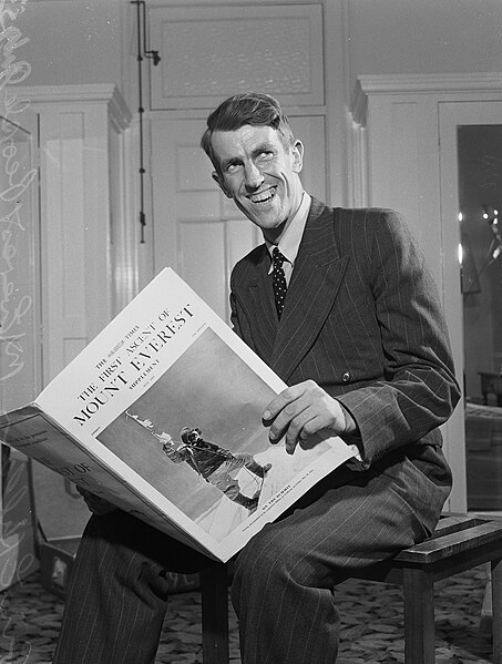 Edmund Hillary reading The Times, with his photo of fellow summiteer Tenzing Norgay on the cover, July 1953