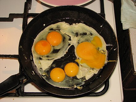 Eggs being gently fried Five yolks from three eggs.JPG