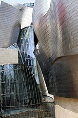 The museum is clad in glass, titanium, and limestone