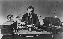 Marconi demonstrating apparatus he used in his first long-distance radio transmissions in the 1890s. The transmitter is at right, the receiver with paper tape recorder at left. Guglielmo Marconi 1901 wireless signal.jpg
