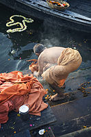 A holy friar monk washes in the Ganges Varanasi Benares India