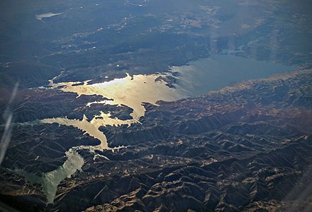 Aerial view of Lake Berryessa, looking west into the evening sun