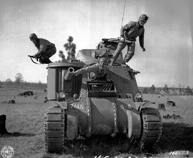 Crew exiting a "disabled tank" during maneuvers held at Camp Polk in February 1943