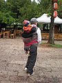 Man carrying child at Black Dragon Pool