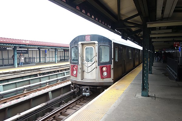 A Woodlawn-bound 4 local train made up of 10 R142 Cars leaves the Mosholu Parkway station before the last stop on the line, Woodlawn.