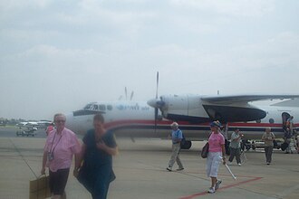 Passengers disembark from a PMTair Antonov An-24 at Phnom Penh International Airport in September 2006. PMTair 20060914 Phnom Penh.jpg