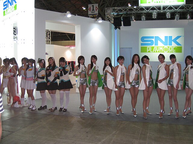 SNK Playmore exposition at the TGS in 2007, including two promotional models dressed as the company mascot, Mai Shiranui (far left)