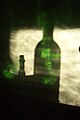 Sun light and shade. Light filtered thru an old window and green bottles.