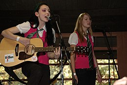 The Parselmouths, a wizard rock band consisting of Brittany Vahlberg and Kristina Horner, perform during Wrockstock in 2007, displaying the Harry Potter-themed costumes common within the genre. Theparselmouthswrockstock.jpg