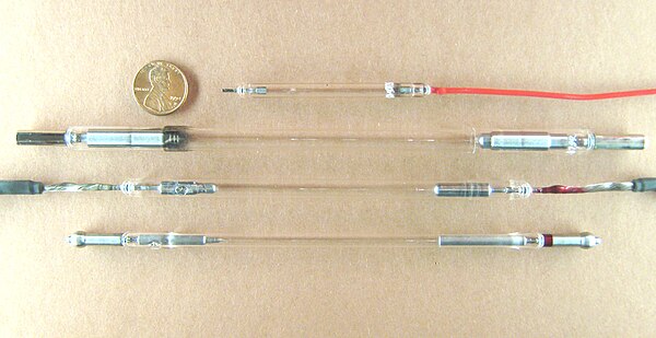 Flashtubes of various sizes for laser pumping. The top three are xenon flashtubes. The last one is a krypton arc lamp, (shown for comparison).