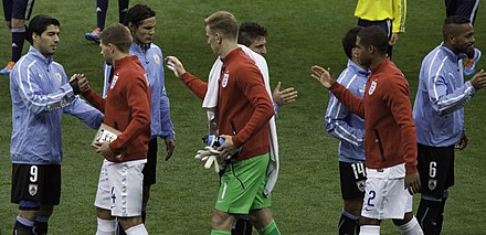 Gerrard (second from left) shaking hands with Uruguay's Luis Suárez at the 2014 FIFA World Cup, 19 June 2014.