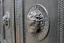 Lion head doorknocker of the Carolingian Wolf's Door AachenerDom1652PortalLoewe.jpg