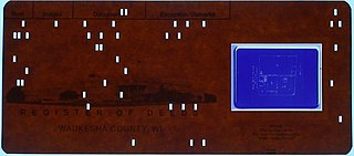 Aperture card punch card in which a piece of microfilm is mounted