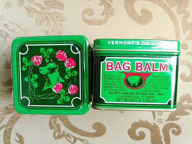 metal container of bag balm shown in top and side view