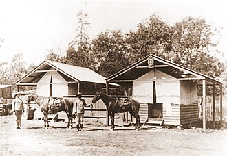 Blackbutt Police Station, 1912. Note the station badge attached to the peak of the right hand tent. Blackbutt Police Station, 1912. Note the station badge attached to the peak of the right hand tent.jpg