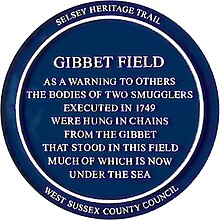 Blue plaque commemorating the hanging of two smugglers in Gibbet Field Selsey in 1749