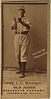 A black and white baseball card featuring a man in a white baseball jersey and striped cap holding both hands out cupped in front of his chest.