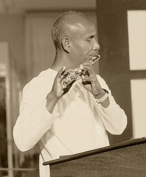 Sri Chinmoy playing flute