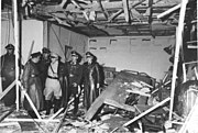 Several people looking inside a destroyed room