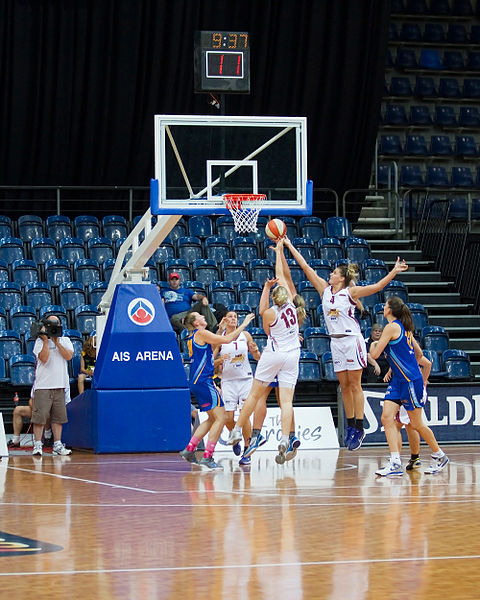 WNBL teams, the Logan Thunder in white and the University of Canberra Capitals in blue, battle for the ball in a game on 20 January 2012.