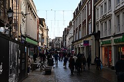 Looking down onto Whitefriargate in Kingston upon Hull during Christmastime, where a handful of decorations are up and the pedestrianised street is notoriously low on Christmas shoppers.