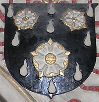Arms of Still: Sable gutte d'eau argent, 3 roses of the last seeded or barbed vert. These arms were granted by Sir William Dethick, Garter King of Arms, on 10 April 1593, on his elevation to the bishopric. The thorns of the roses in the arms, here depicted above the Bishop's tomb in Wells Cathedral, are painted not "vert" (green) but "or" (gold). Jewers noted in his 19th-century book that the monument had been newly painted Coat of arms of John Still at his tomb in Wells Cathedral, Somerset, UK - 20100930.jpg