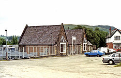 The main station building in 1992, showing the demolished wings and central section, about to be redeveloped as a showroom Corwen station, exterior geograph-3321394-by-Ben-Brooksbank.jpg