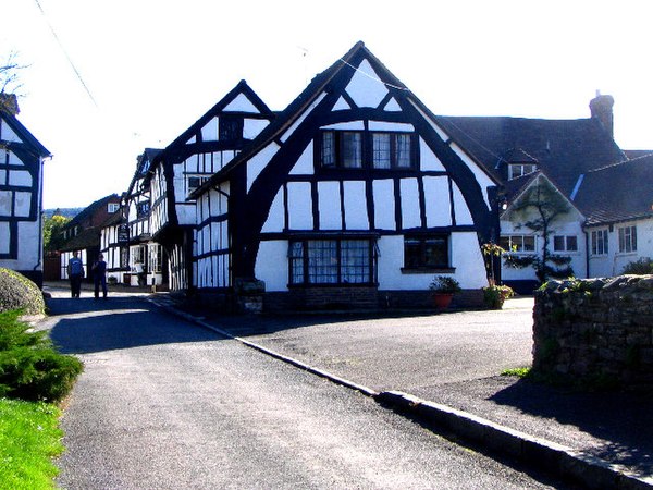A "true" or "full" cruck half-timbered building in Weobley, Herefordshire, England: The cruck blades are the tall, curved timbers which extend from ne