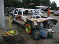 A spray-painted wrecked car that had been used in a demolition derby wreck, wrecked, scrap, car, junk, demolished, spray-paint