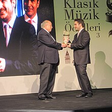 Mehmet Erhan Tanman, receiving "Young Musician of The Year" award from Sefik Kahramankaptan - Donizetti Classical Music Awards(2013) Donizetti Awards.jpg