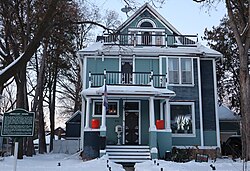 Two-and-a-half story frame house with two balconies