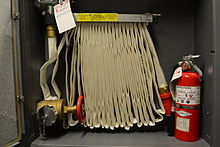 Indoor fire hose with a fire extinguisher FireHose2.JPG