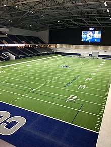 Photo of the inside of an empty Ford Center at the Star, an indoors stadium from one of the upper corner sections