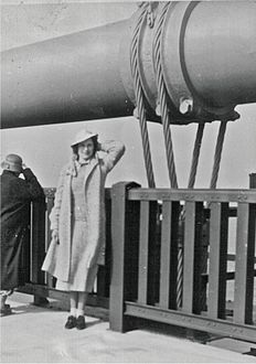 A pedestrian poses at the old railing on opening day, 1937