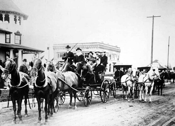 H. J. Whitley (on left wearing a bowler hat) and the Hollywood Hotel (on left) at the corner of Highland Avenue and Hollywood Boulevard