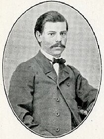 Upper body image of a seated young distinguished-looking gentleman with moustache
