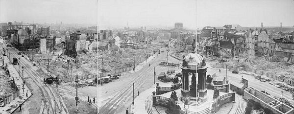 A panoramic view of bomb damage in Liverpool; Victoria Monument in foreground, the burned-out shell of the Custom House in middle distance